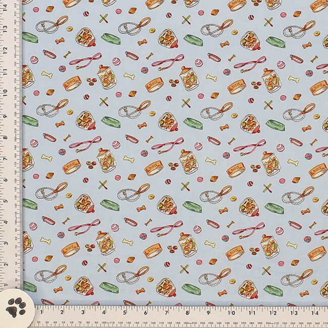 Dog Leashes, Dog Bowls, Dog Treats, and Dog Toys are printed throughout light creamy colored background fabric made from All Cotton Fabric 44 inches wide. Made by Cloth Works.