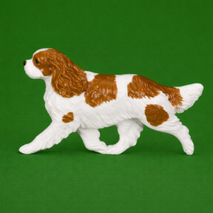 Hand-painted break-resistant acrylic resin dog magnet featuring a full-body Cavalier Bleheim in a gaiting pose, designed to attach to metal surfaces.