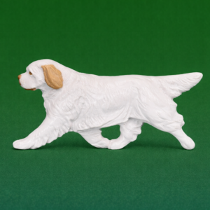 Hand-painted break-resistant acrylic resin dog magnet featuring a full-body Clumber-Spaniel in a gaiting pose, designed to attach to metal surfaces.