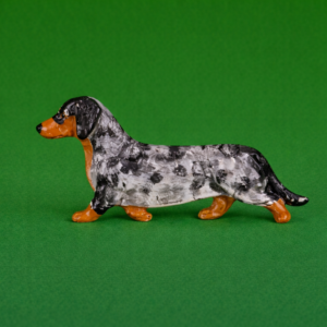 Hand-painted break-resistant acrylic resin dog magnet featuring a full-body Dachshund-Dapple in a gaiting pose, designed to attach to metal surfaces.