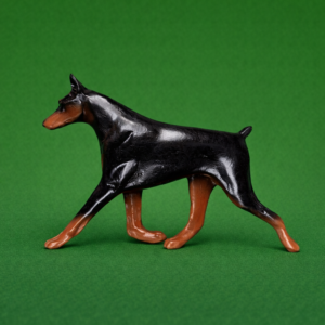 Hand-painted break-resistant acrylic resin dog magnet featuring a full-body Doberman-Pinscher in a gaiting pose, designed to attach to metal surfaces.