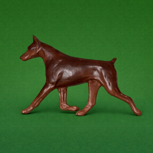 Hand-painted break-resistant acrylic resin dog magnet featuring a full-body Doberman-Pinscher-Red in a gaiting pose, designed to attach to metal surfaces.